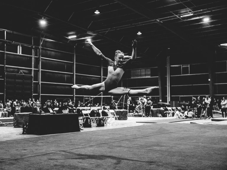 Elite gymnast Greta Stowell performing a dynamic floor routine, showcasing her skills as a top college recruit.