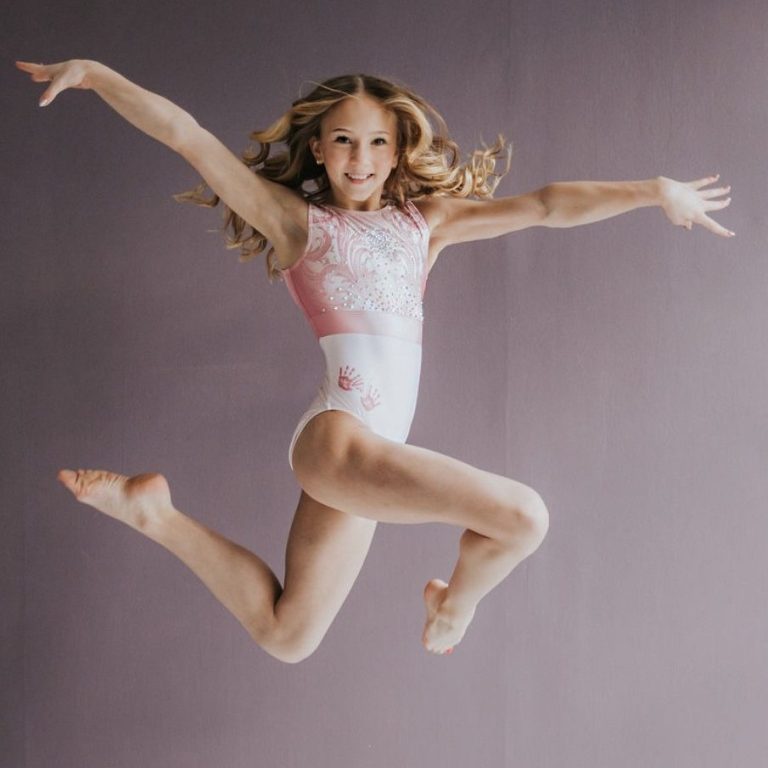 Greta Stowell performing a gymnastics skill and displaying her love of competition. 